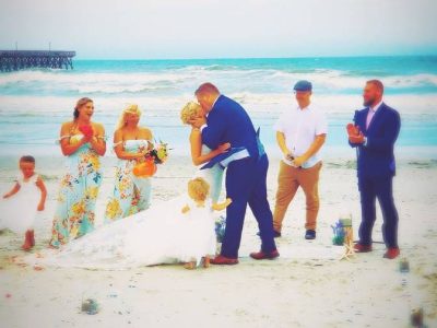 Wedding DJ services Syracuse serving as officiant to a couple getting married on a South Carolina beach